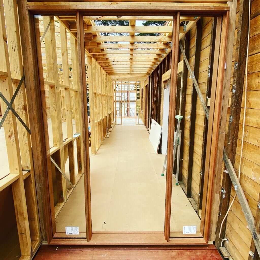 A view inside a construction site with completed wall and door framing