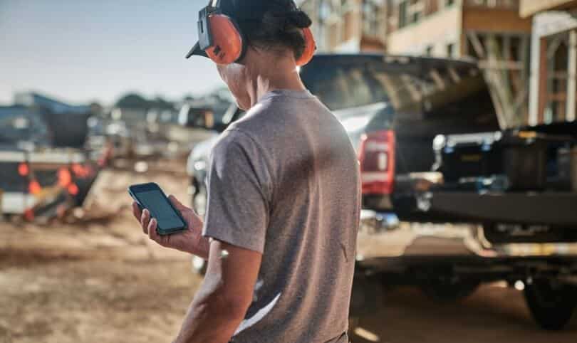 A builder on-site using Buildxact on their mobile phone