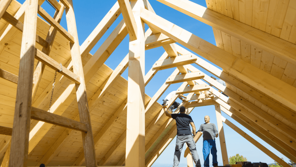 Four builders working on a roof