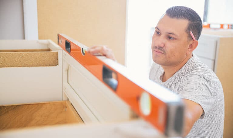 A builder using a spirit level