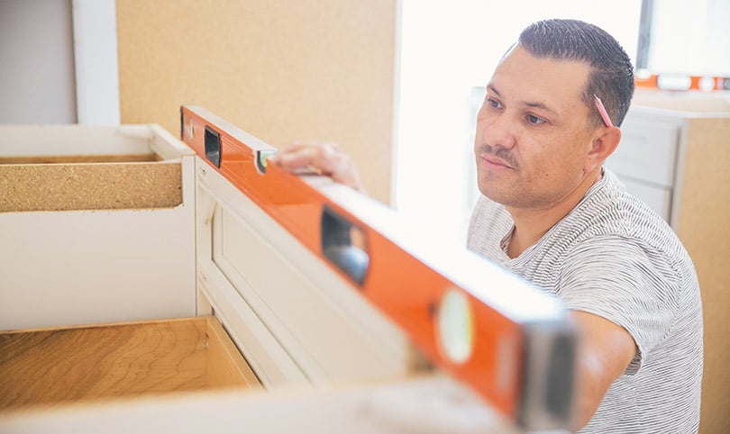 A builder using a spirit level