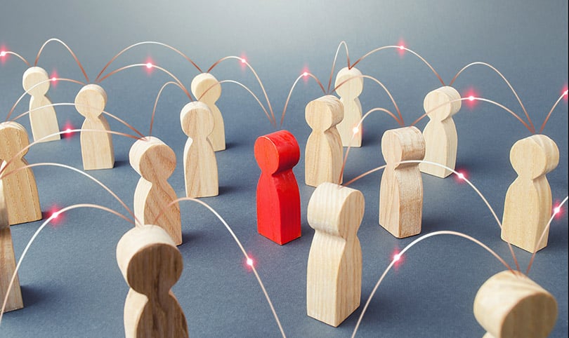 A red wooden person surrounded by white wood blocks all connected by a thought