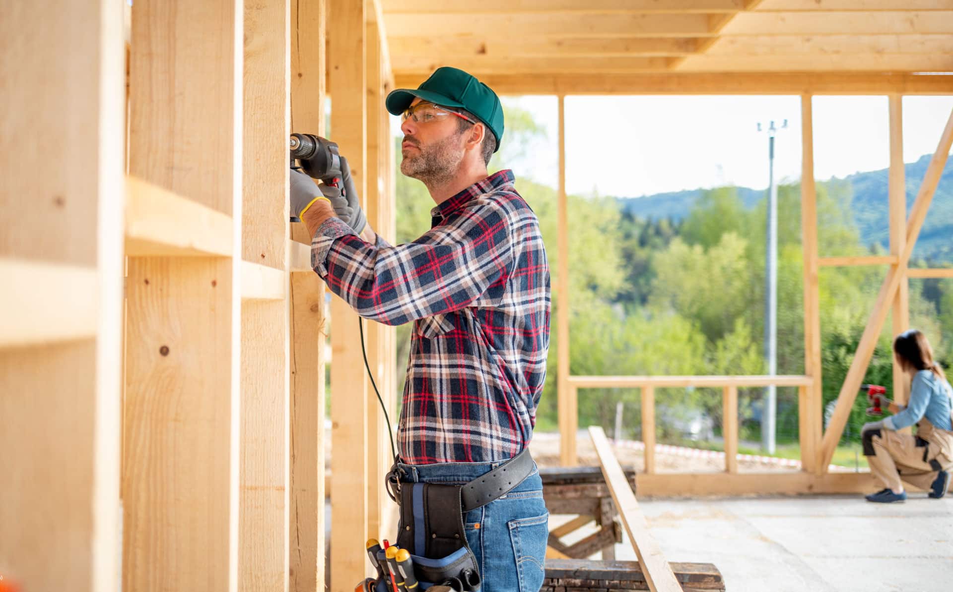 A builder frames an interior wall.