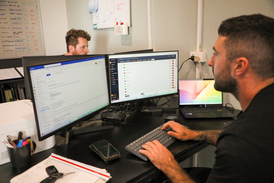 Home builders perform admin work on their office computers