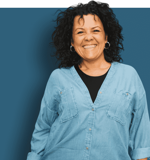 A photo of a woman in a blue shirt smiling to the camera