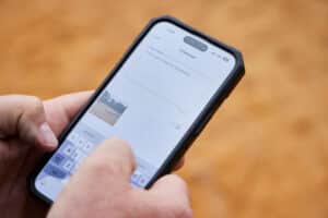 A Buildxact customer uses his mobile phone to log a project update.