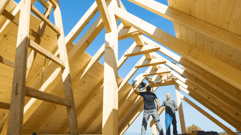 Four builders working on a roof