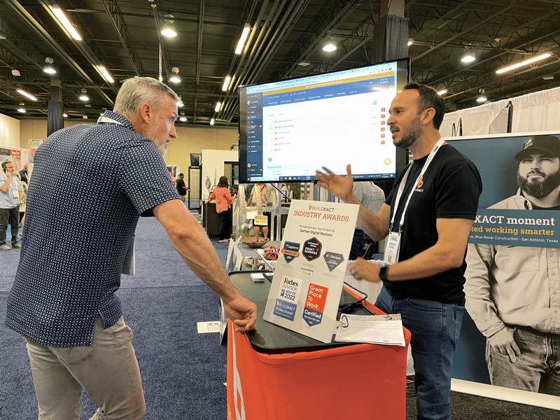 a builder visits a Buildxact team member at a building conference