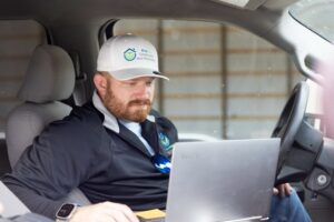 Builder Josh Bradley checks his project plan using a laptop