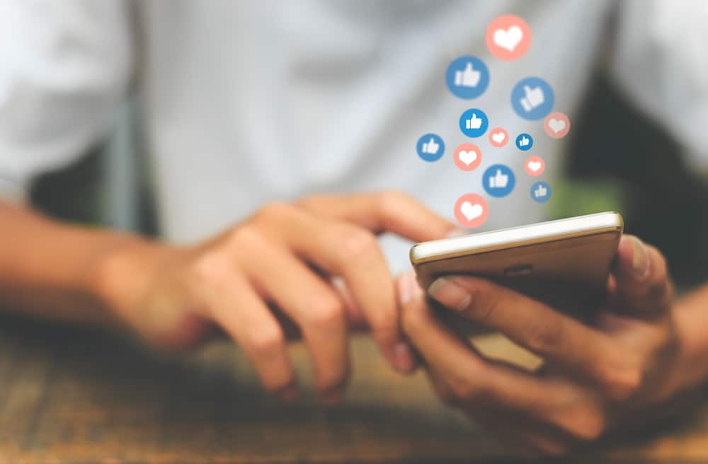 A social media user interacts with content on their mobile app