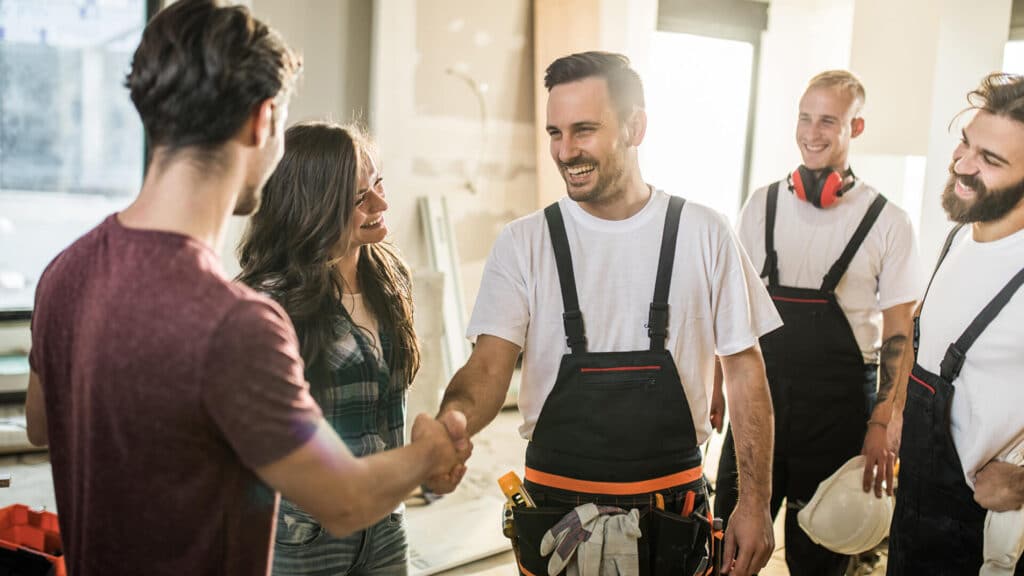 Builders meeting clients on a job site
