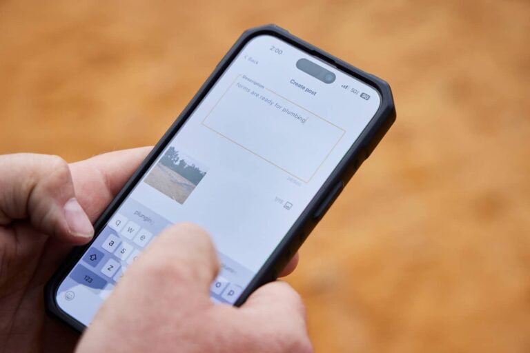 A buildxact customer uses his mobile device to perform a project update.