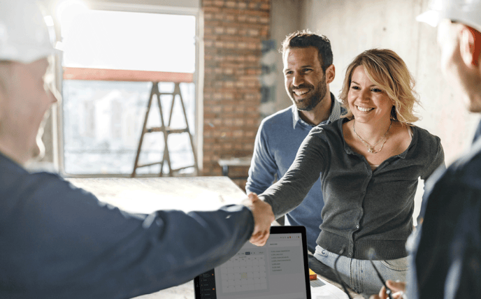 Builder meeting clients on jobsite