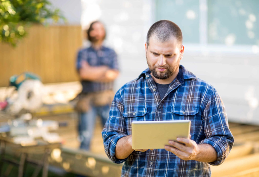 man holding tablet looking down